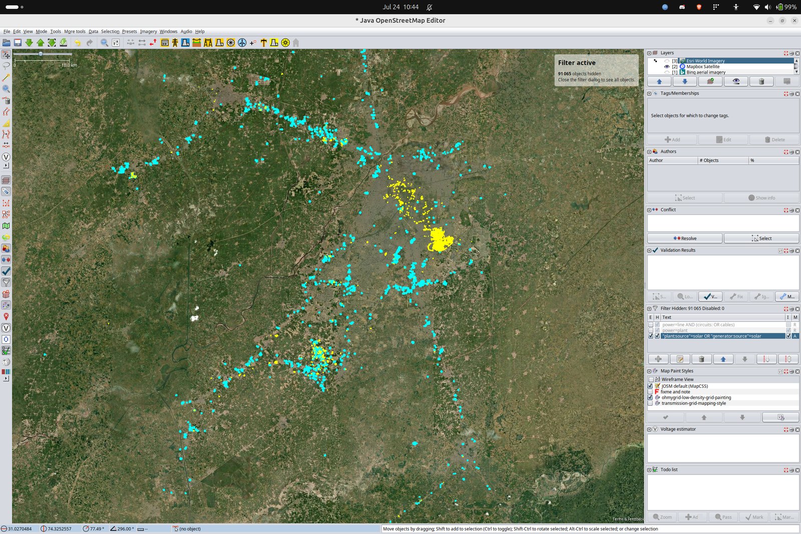The JOSM layer panel showing three background imagery layers stacked and switchable: Esri World Imagery, Mapbox Satellite and Bing aerial imagery. The map below is a 10 kilometre wide view around Lahore with a filter active that has hidden 91,065 objects, leaving only features tagged as solar visible as scattered clusters.